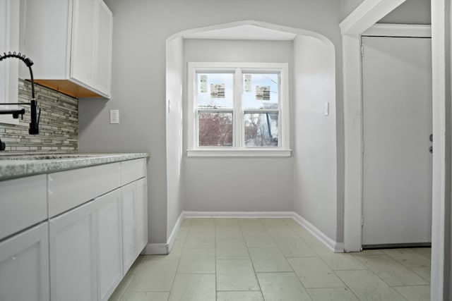 kitchen featuring white cabinetry and tasteful backsplash