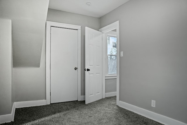 unfurnished bedroom featuring carpet floors and a closet