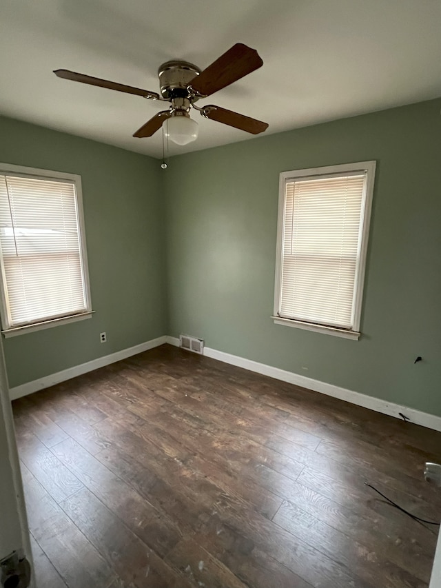 unfurnished room featuring ceiling fan and dark hardwood / wood-style flooring