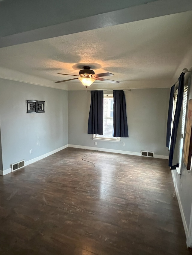 unfurnished room with ceiling fan and a textured ceiling