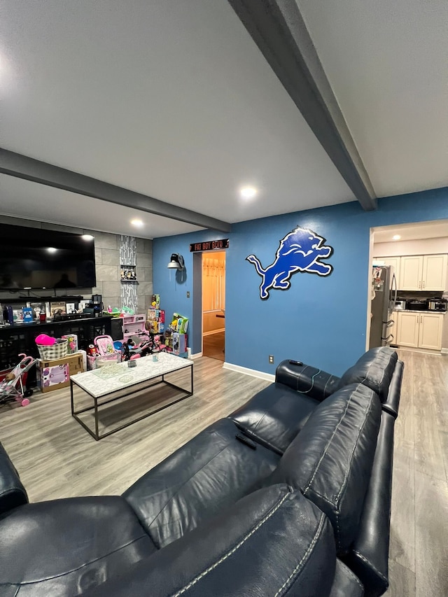 living room featuring light hardwood / wood-style floors and beam ceiling