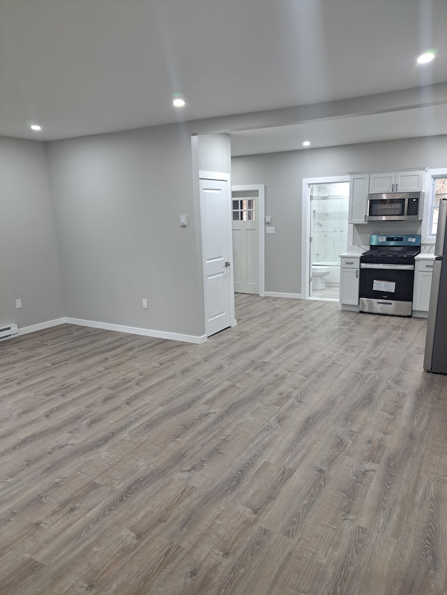 unfurnished living room featuring light wood-type flooring