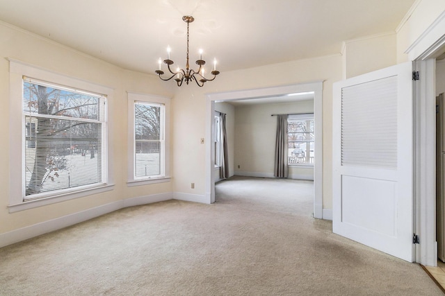 unfurnished dining area featuring an inviting chandelier, crown molding, and light colored carpet