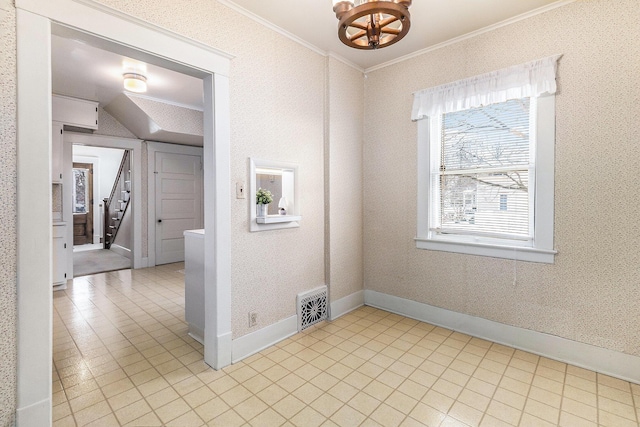 unfurnished room featuring a chandelier and crown molding