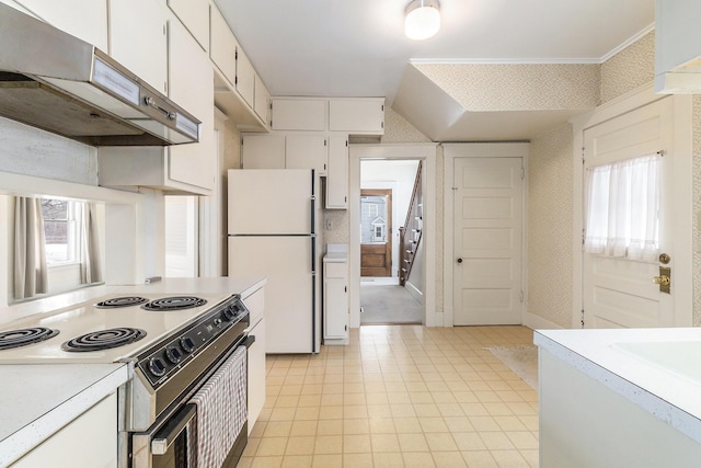 kitchen with stainless steel range with electric cooktop, white fridge, and white cabinetry