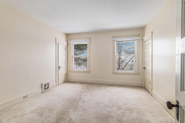 spare room with light colored carpet