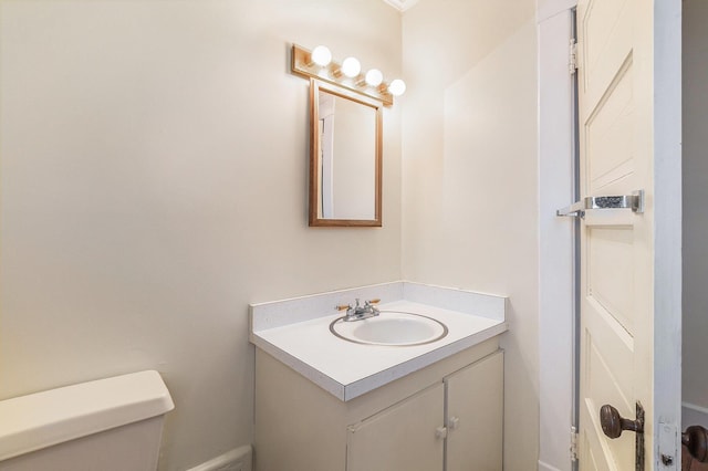 bathroom with toilet and vanity