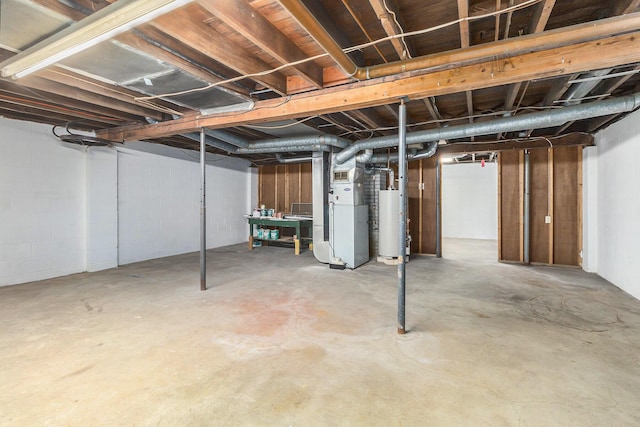 basement featuring heating unit and water heater