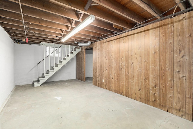 basement featuring wood walls