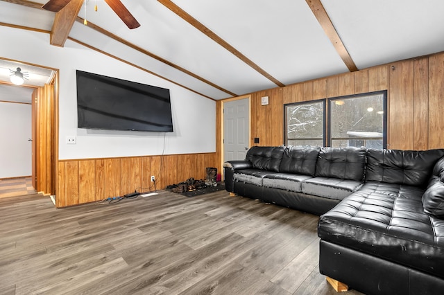 living room with ceiling fan, hardwood / wood-style flooring, and lofted ceiling with beams