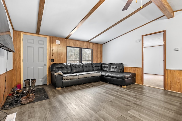 living room featuring ceiling fan, hardwood / wood-style flooring, and lofted ceiling with beams