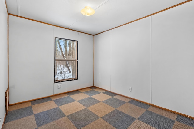 unfurnished room featuring carpet and ornamental molding