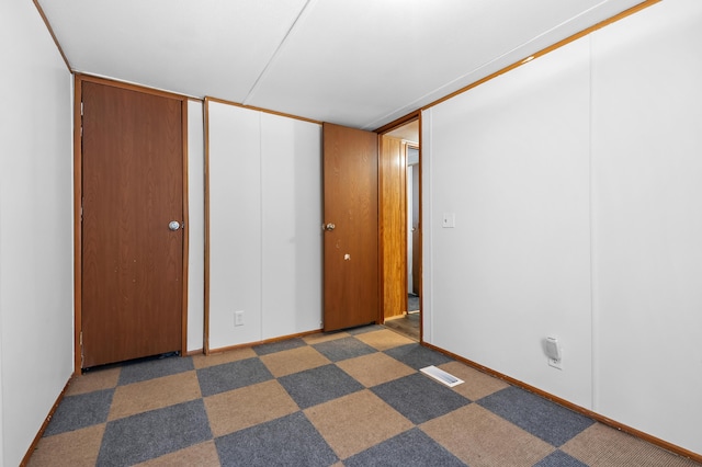 unfurnished bedroom featuring dark colored carpet