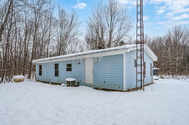 view of snow covered back of property