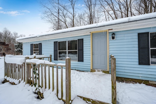 view of snow covered property entrance