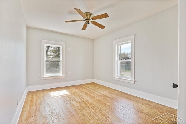 unfurnished room featuring ceiling fan, a healthy amount of sunlight, and light wood-type flooring