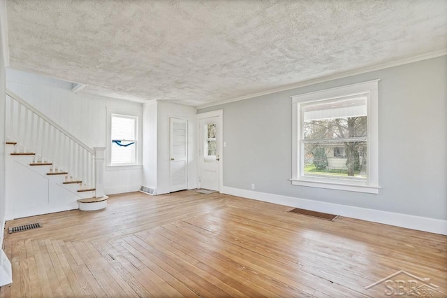 interior space with ornamental molding and wood-type flooring