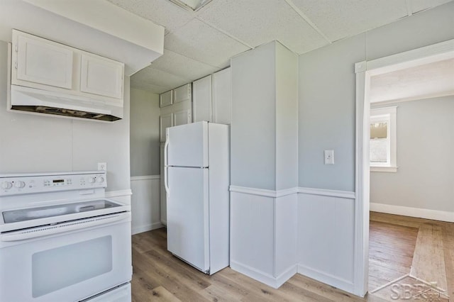 kitchen with white cabinetry, white appliances, a drop ceiling, and custom exhaust hood