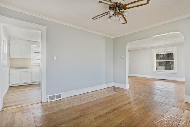 unfurnished room with ceiling fan, crown molding, and light hardwood / wood-style flooring