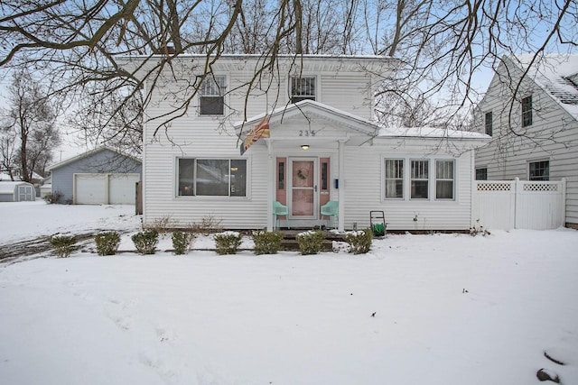 view of front facade featuring a garage and an outbuilding