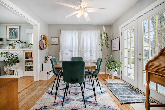 dining room featuring ceiling fan, light hardwood / wood-style flooring, and french doors