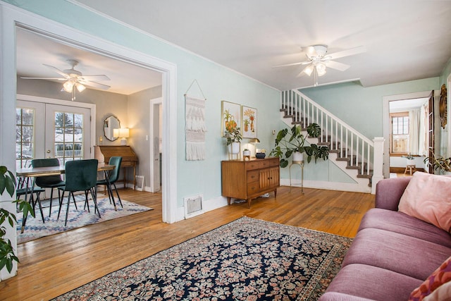 living room featuring ceiling fan, french doors, and hardwood / wood-style flooring