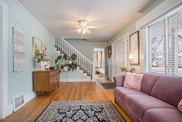 living room featuring ceiling fan and light wood-type flooring