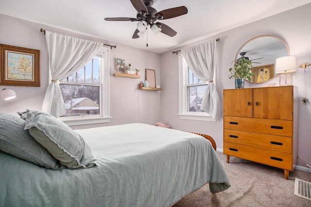 bedroom with ceiling fan, carpet, and multiple windows