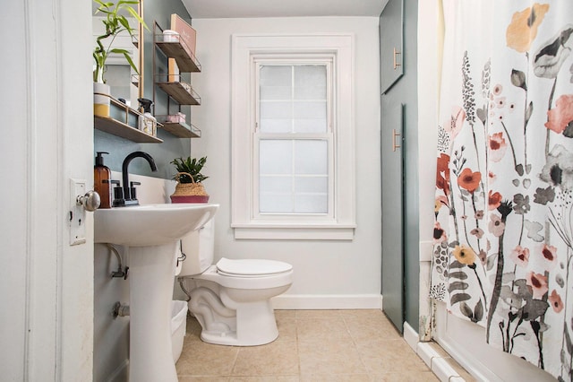 bathroom featuring toilet and tile patterned flooring