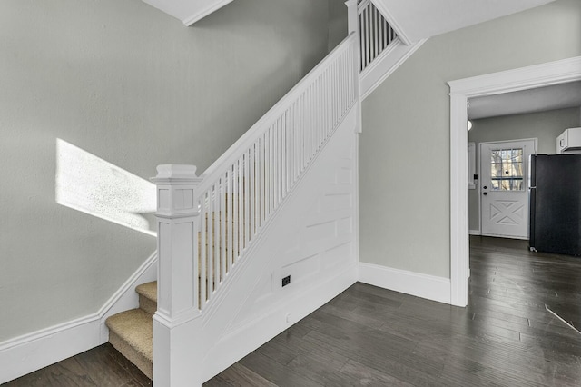 stairway with hardwood / wood-style floors