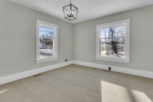 unfurnished dining area featuring carpet and a notable chandelier