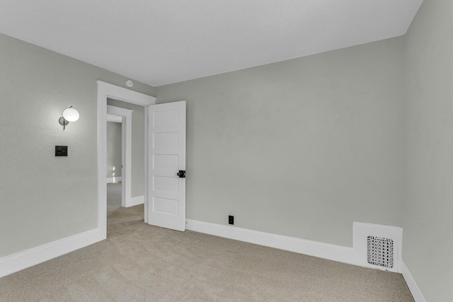 empty room featuring light colored carpet