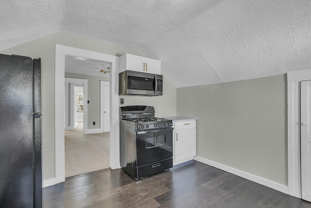 kitchen featuring vaulted ceiling, black appliances, dark wood-type flooring, a textured ceiling, and white cabinets