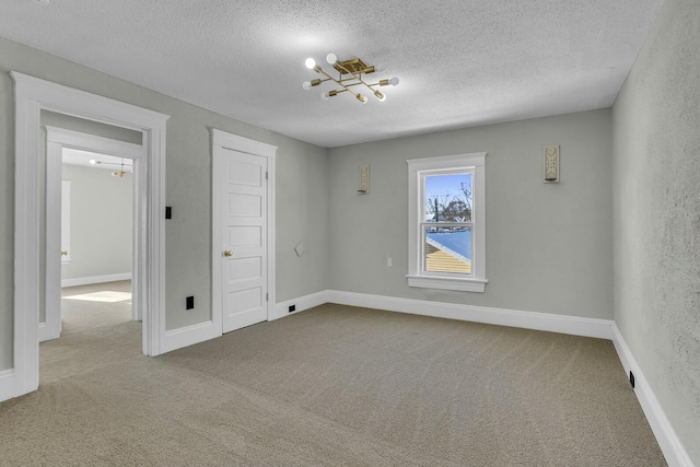 unfurnished bedroom with light colored carpet and a textured ceiling