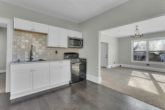 kitchen featuring white cabinets, sink, dark hardwood / wood-style floors, a chandelier, and gas range oven