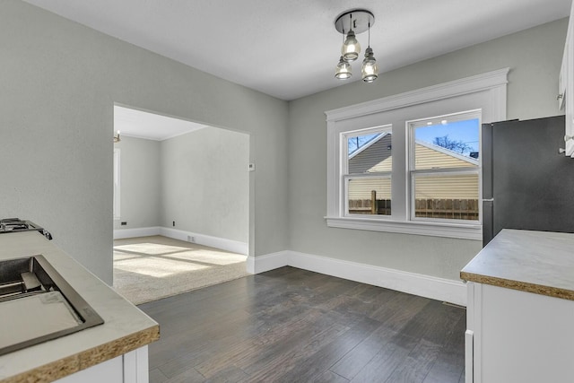 dining area featuring dark wood-type flooring