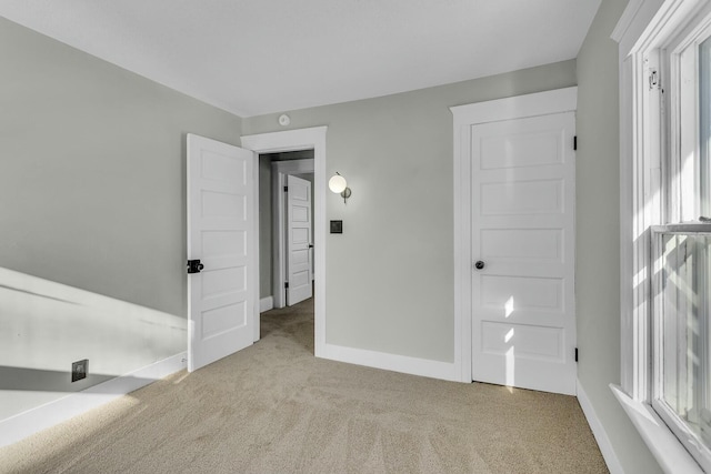 unfurnished bedroom featuring light colored carpet