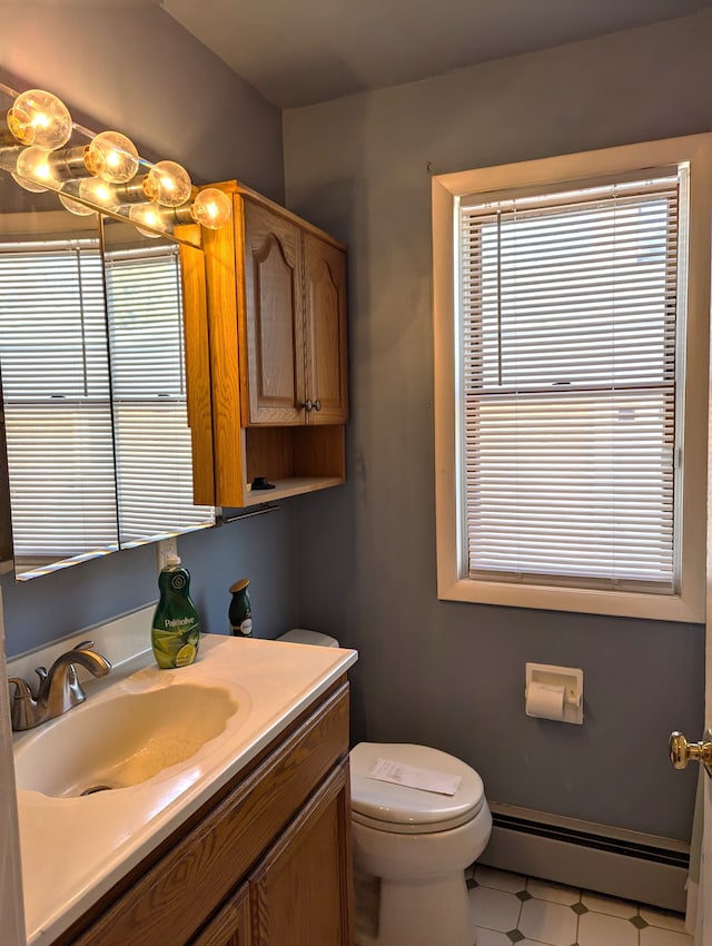 bathroom featuring a baseboard radiator, vanity, and toilet