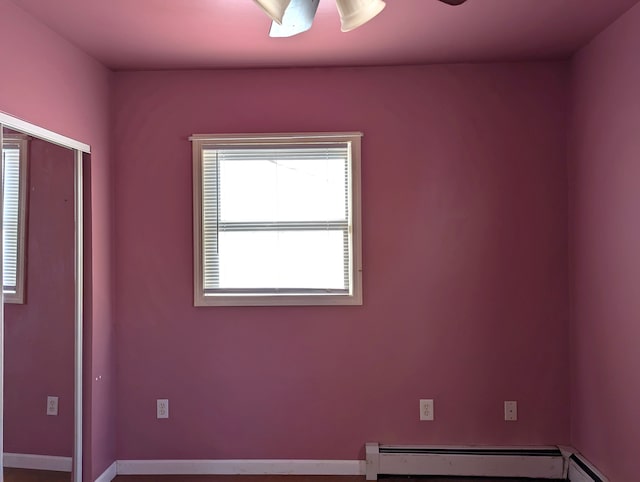 empty room featuring ceiling fan and baseboard heating