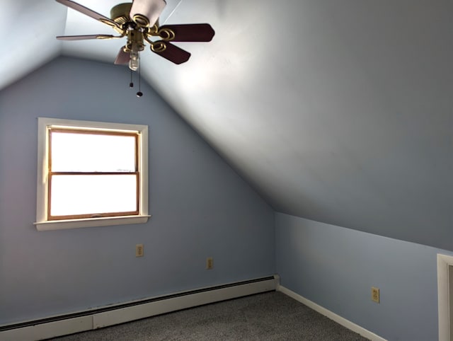 additional living space with ceiling fan, a baseboard radiator, carpet flooring, and vaulted ceiling