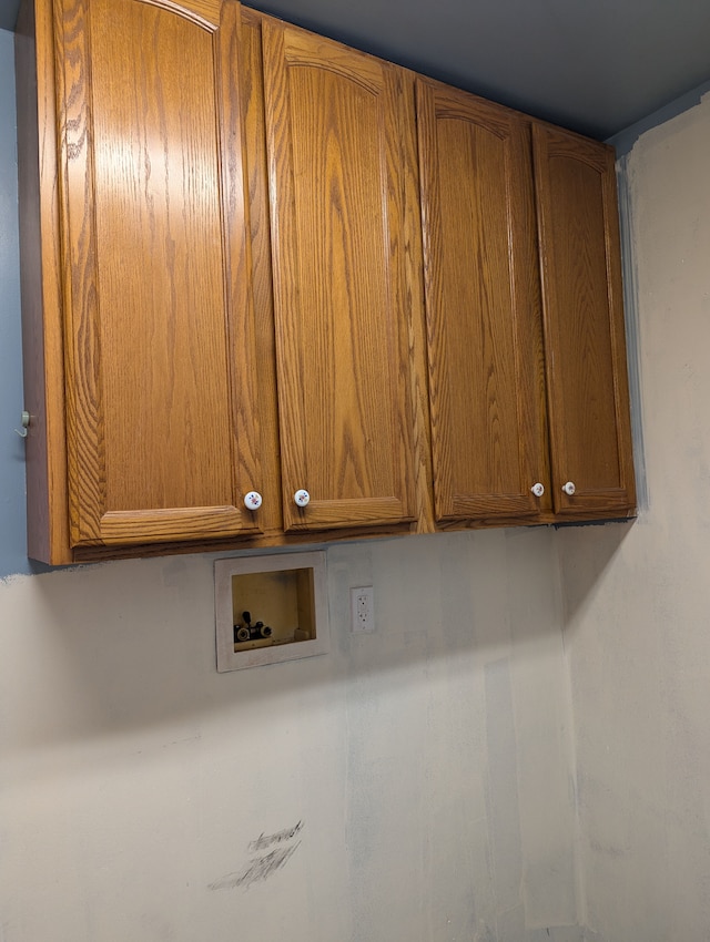 clothes washing area featuring cabinets and hookup for a washing machine