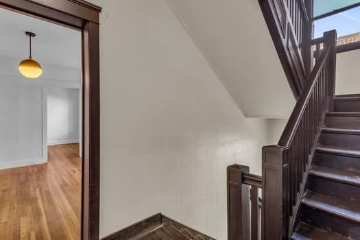 stairs featuring wood-type flooring