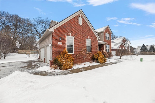 view of snow covered exterior featuring a garage