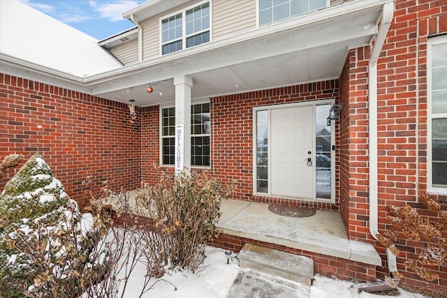 view of snow covered property entrance