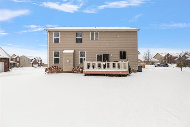 snow covered property with a wooden deck