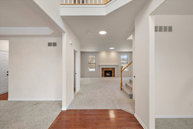 corridor featuring ornamental molding and carpet floors