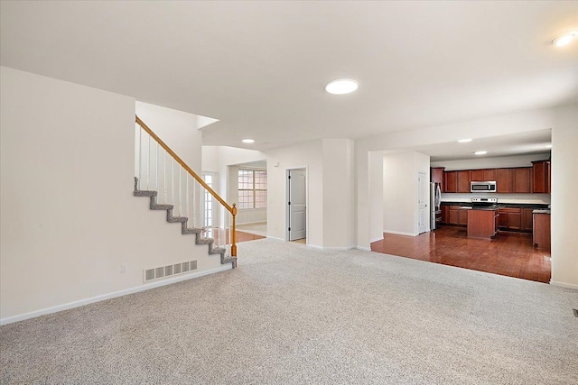 unfurnished living room with dark carpet