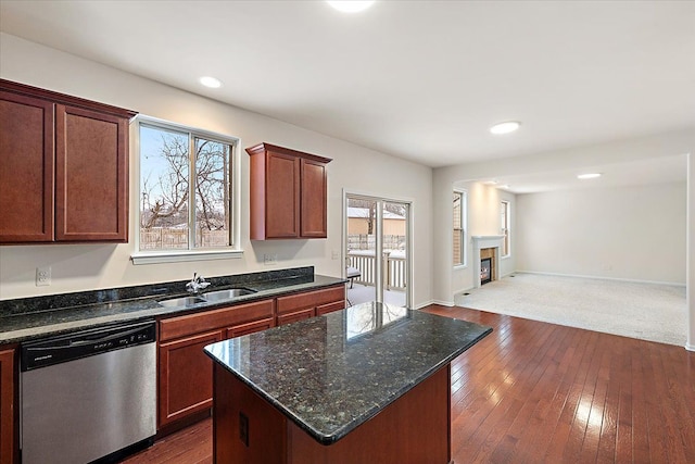 kitchen featuring a center island, dark stone countertops, sink, dark hardwood / wood-style floors, and stainless steel dishwasher