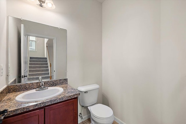 bathroom featuring toilet and vanity