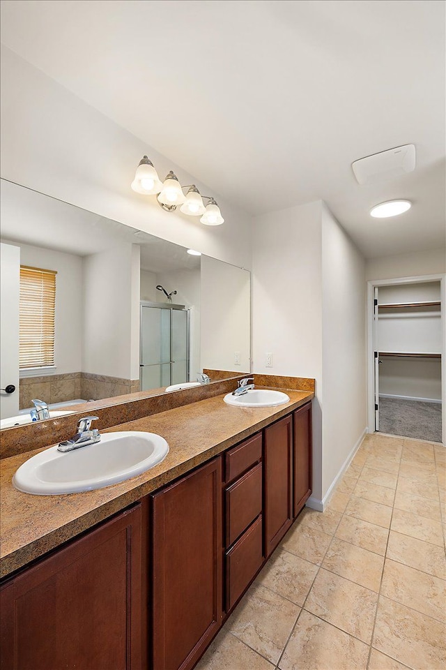 bathroom with vanity and a shower with door